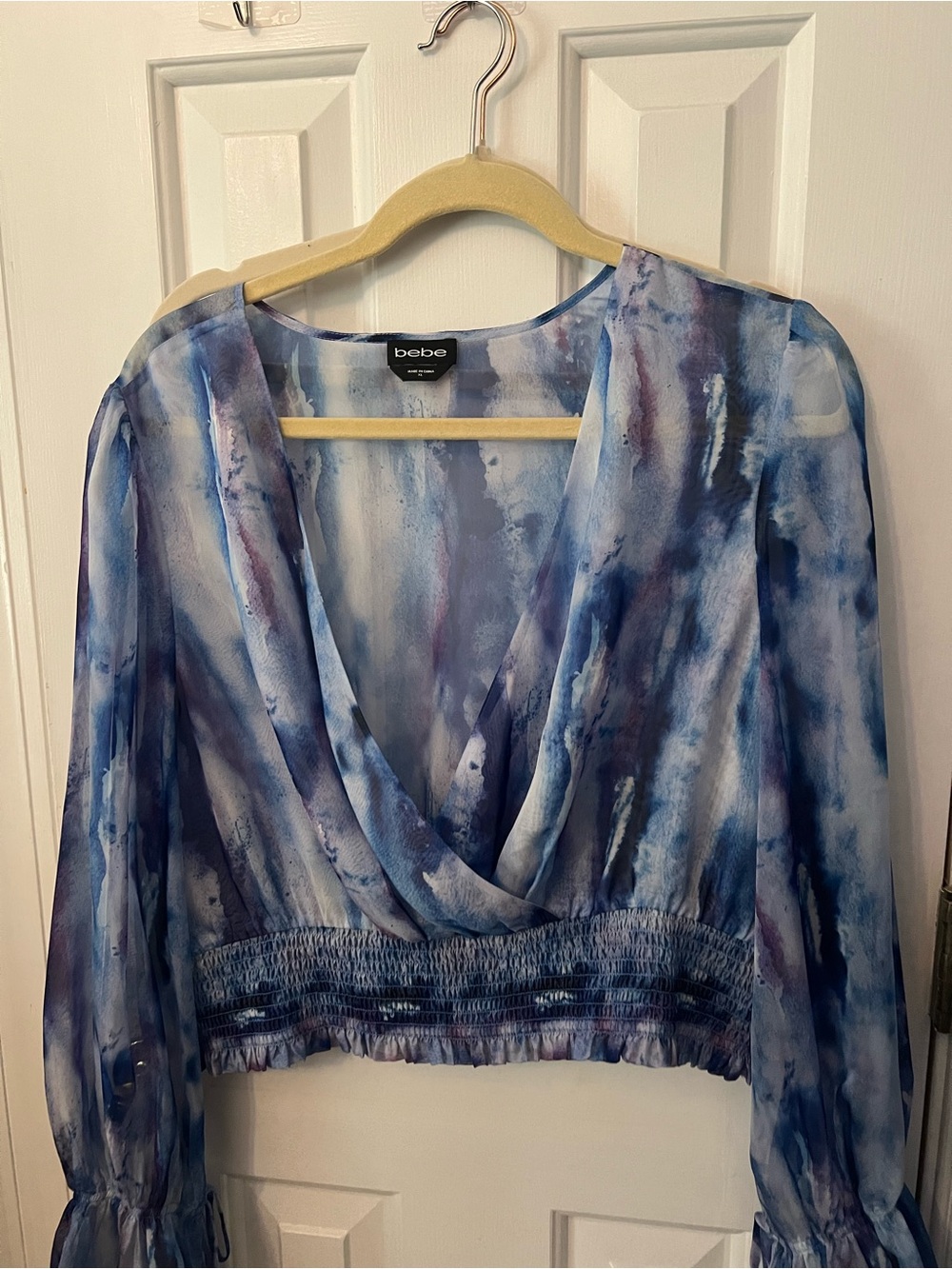 bebe Blue Watercolor V-Neck Smocked Waist Crop Blouse - Picture 1 of 2